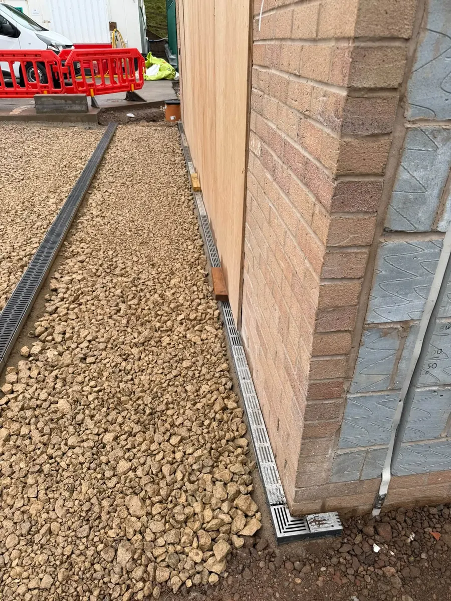 Aco channel drain installed along a building wall, GRW Homes groundworks on a school project