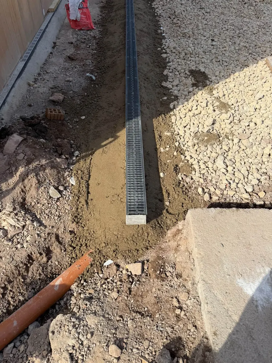 Aco channel drain bedded in concrete with a drain pipe connection, GRW Homes groundworks on a school project