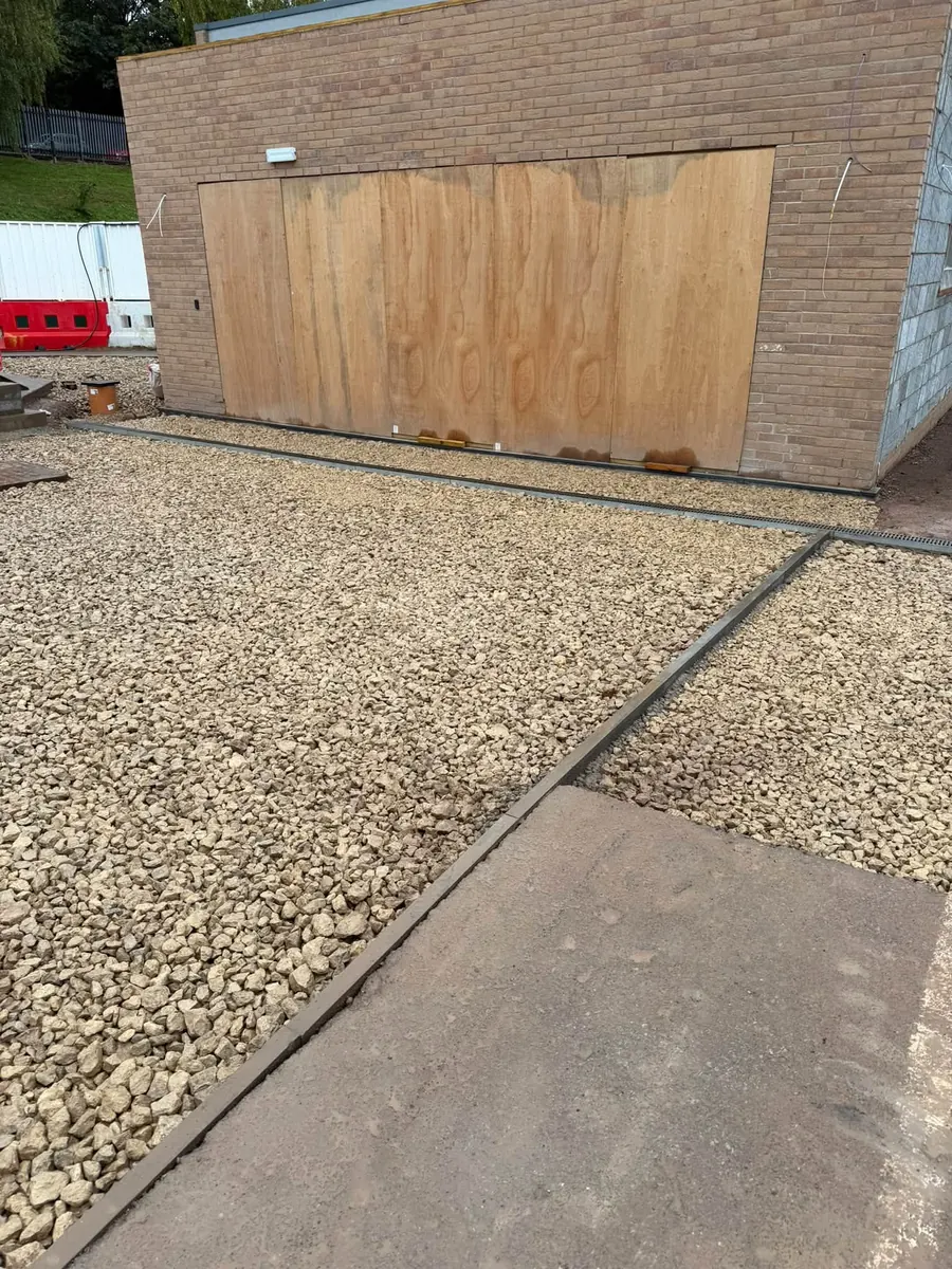 Concrete edging and compacted sub-base beside a building, GRW Homes groundworks on a school project