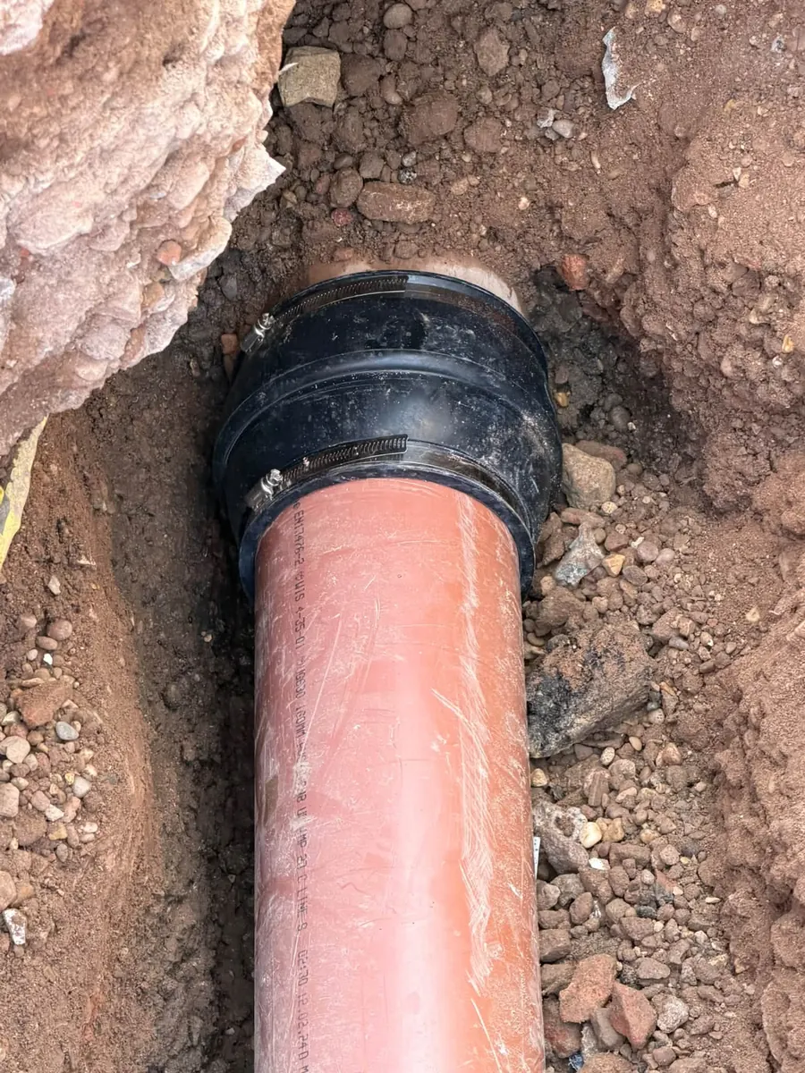 Drain pipe joined with a rubber repair coupling, GRW Homes groundworks on a school project