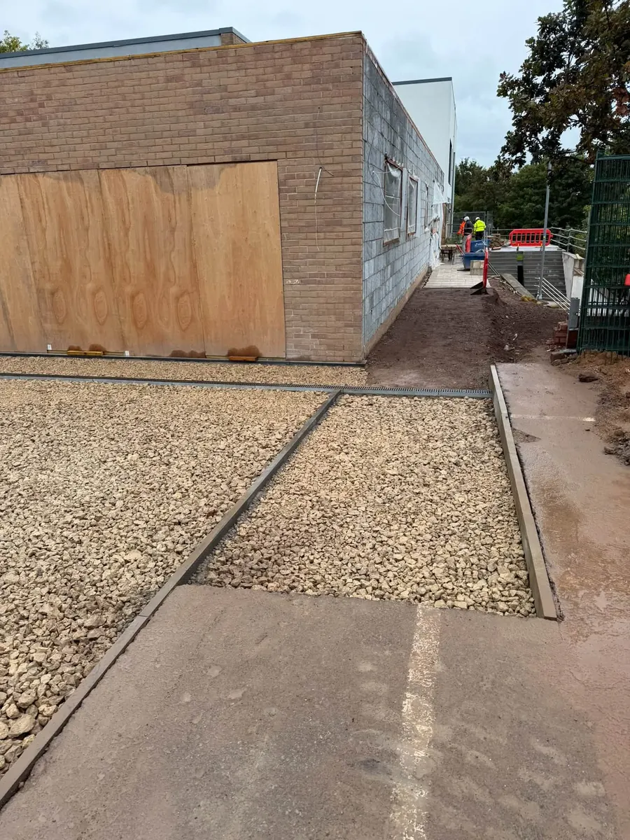 Edgings and sub-base laid by a boarded building, GRW Homes groundworks on a school project